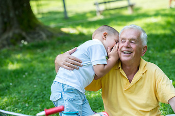 Image showing grandfather and child have fun  in park