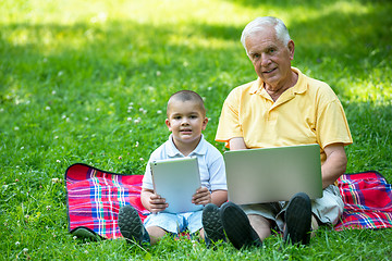 Image showing grandfather and child using laptop