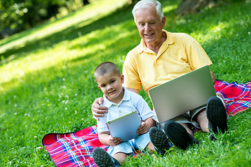 Image showing grandfather and child using laptop