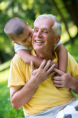 Image showing grandfather and child have fun  in park