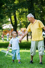 Image showing grandfather and child have fun  in park