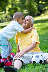 Image showing grandfather and child have fun  in park