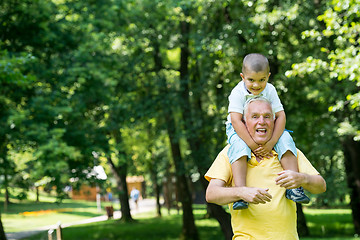 Image showing grandfather and child have fun  in park