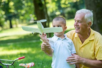 Image showing grandfather and child have fun  in park