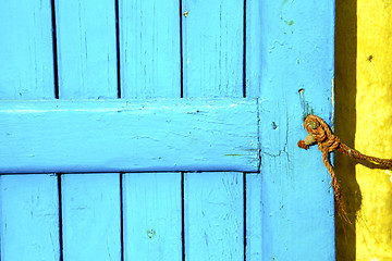 Image showing blue metal rusty  brown    morocco in yellow rope