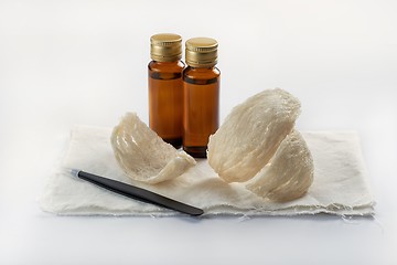 Image showing Edible birdnest with essence bottle and pincer