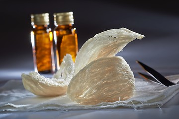 Image showing Edible birdnest with essence bottle and pincer