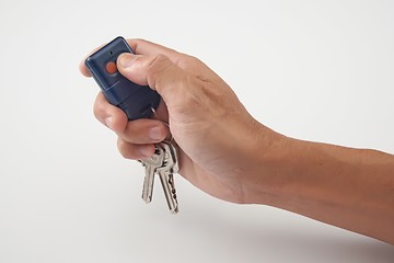 Image showing Hand press the remote control with keys