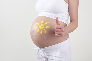 Image showing Pregnant woman with yellow sun painted on her belly