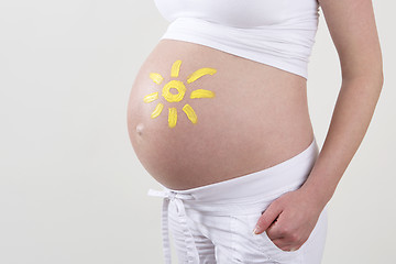 Image showing Pregnant woman with yellow sun painted on her belly