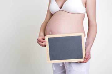 Image showing Pregnant woman with an empty blackboard