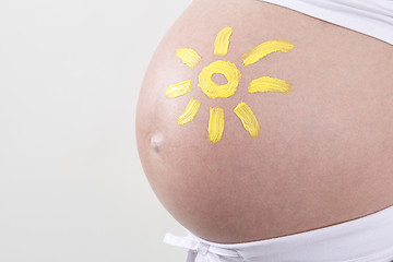 Image showing Pregnant woman with yellow sun painted on her belly