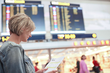 Image showing Woman tourist looking at timetable in airport