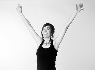 Image showing Woman Celebrates Winning Attitude Arms Outstretched Reaching Upw