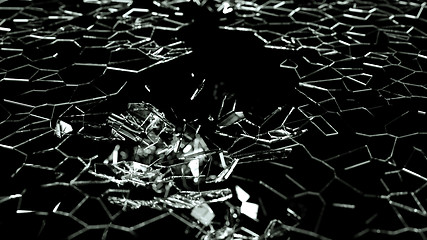 Image showing Broken and splitted glass pieces on black