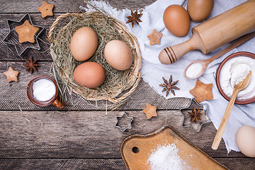 Image showing Christmas homemade cookies and ingredients on wood