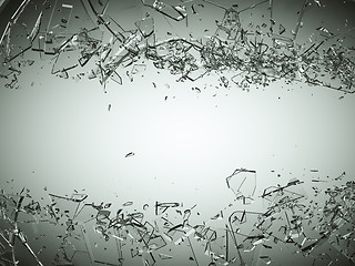 Image showing Pieces of splitted or cracked glass on grey