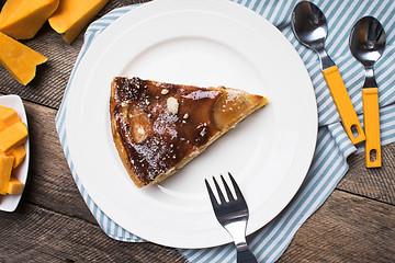 Image showing pieces of pie and cut pumpkin on table in Rustic style