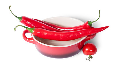 Image showing Chili peppers on the saucepan and cherry tomatoes near