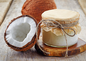 Image showing jar of coconut oil and fresh coconuts