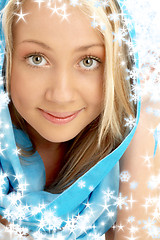 Image showing smiling blond in blue scarf with snowflakes