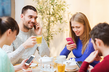 Image showing group of friends with smartphones meeting at cafe