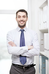 Image showing handsome businessman with crossed arms at office