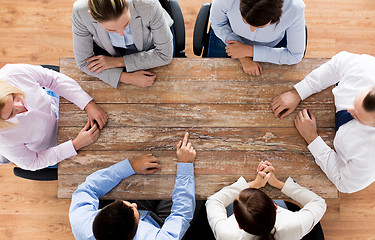 Image showing close up of business team sitting at table