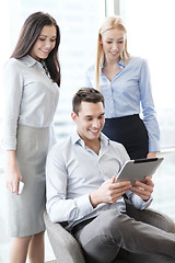 Image showing business team working with tablet pc in office