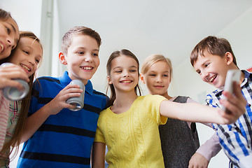 Image showing group of school kids with smartphone and soda cans