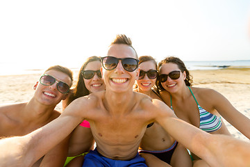 Image showing group of smiling friends making selfie on beach