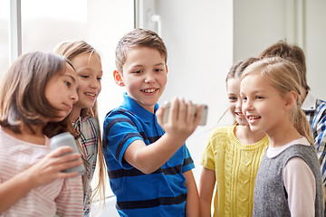 Image showing group of school kids with smartphone and soda cans