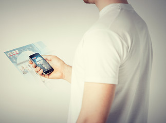 Image showing man with smartphone reading news