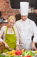 Image showing happy male chef cook with woman cooking in kitchen