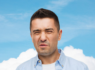 Image showing man wrying of unpleasant smell