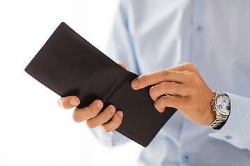 Image showing close up of businessman hands holding open wallet