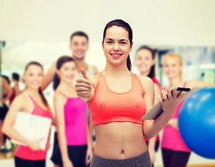 Image showing sporty woman with tablet pc computer