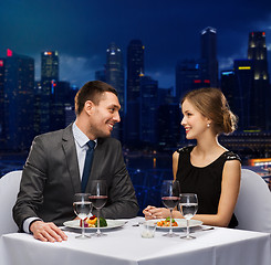 Image showing smiling couple talking at restaurant