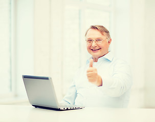 Image showing old man with laptop computer showing thumbs up