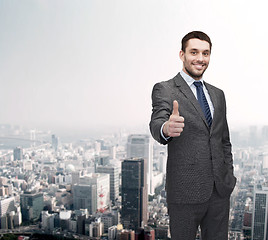 Image showing handsome buisnessman showing thumbs up