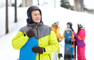 Image showing happy friends in helmets with snowboards