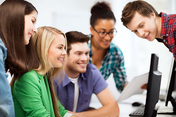 Image showing students looking at computer monitor at school