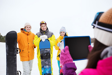 Image showing happy friends with snowboards and tablet pc