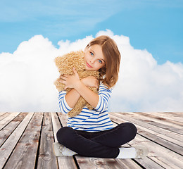 Image showing cute little girl hugging teddy bear