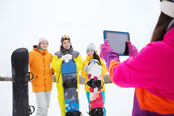 Image showing happy friends with snowboards and tablet pc