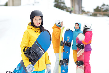 Image showing happy friends in helmets with snowboards