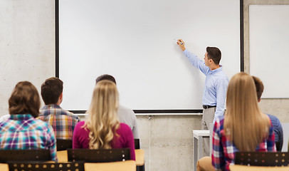 Image showing group of students and smiling teacher in classroom