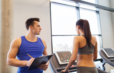 Image showing woman with trainer on treadmill in gym