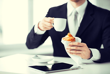 Image showing man with tablet pc and cup of coffee