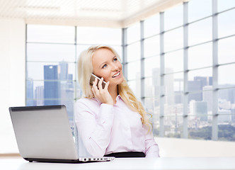 Image showing smiling businesswoman calling on smartphone